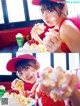 A woman in a red hat eating a piece of cake.